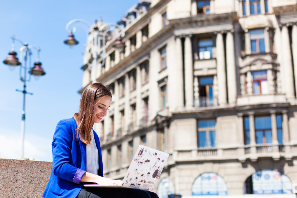 woman-sits-street-works-with-laptop.jpg